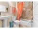 Bathroom with a pedestal sink, toilet and shower with tile surround at 233 Durrance St, Punta Gorda, FL 33950