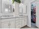 Modern bathroom with double sinks, granite countertops, and a walk-in closet at 233 Durrance St, Punta Gorda, FL 33950