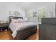 Comfortable bedroom with a king bed, wood floors and shuttered windows at 233 Durrance St, Punta Gorda, FL 33950