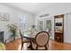 Bright dining room with a round wood table, seating for five, and view to the outdoors at 233 Durrance St, Punta Gorda, FL 33950