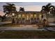 Charming coastal home featuring mature palms, a welcoming porch and lush landscaping at 233 Durrance St, Punta Gorda, FL 33950