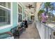 Welcoming front porch featuring a seating area and vibrant turquoise exterior at 233 Durrance St, Punta Gorda, FL 33950