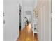 Bright and airy hallway with hardwood floors, neutral walls, and elegant decor at 233 Durrance St, Punta Gorda, FL 33950