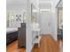 Light-filled hallway featuring hardwood floors, neutral walls, and plantation shutters at 233 Durrance St, Punta Gorda, FL 33950