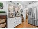 Kitchen with white cabinetry, stainless steel refrigerator, and an adjacent coffee bar area at 233 Durrance St, Punta Gorda, FL 33950