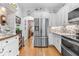 Well-lit kitchen featuring stainless steel appliances, white cabinets, and stylish backsplash at 233 Durrance St, Punta Gorda, FL 33950