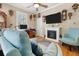 Bright living room featuring a fireplace, hardwood floors, and comfortable seating at 233 Durrance St, Punta Gorda, FL 33950