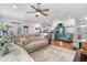 Open-concept living room featuring a neutral sofa, stylish decor, and seamless flow to other living areas at 233 Durrance St, Punta Gorda, FL 33950