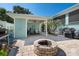 Backyard patio offers covered seating, fire pit, and stylish design for relaxing outdoor gatherings and enjoyment at 233 Durrance St, Punta Gorda, FL 33950