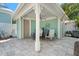 Covered patio features seating, stylish crab artwork, ceiling fan, and serene space for outdoor enjoyment and relaxation at 233 Durrance St, Punta Gorda, FL 33950