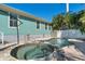 Hot tub beside a sparkling pool with lush landscaping and a calming atmosphere for relaxation and recreation at 233 Durrance St, Punta Gorda, FL 33950