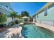 Backyard oasis with swimming pool, hot tub, lush landscaping, and covered outdoor seating area for relaxation at 233 Durrance St, Punta Gorda, FL 33950