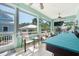 Enclosed sunroom provides ample seating, ceiling fan, and multiple sliding glass windows for indoor/outdoor enjoyment at 233 Durrance St, Punta Gorda, FL 33950