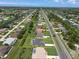 Aerial view showcases a home with a pool and spacious yard, enclosed by yellow property line markers at 260 Rotonda E Blvd, Rotonda West, FL 33947