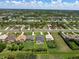 Aerial view showcases a home with a pool and spacious yard, enclosed by yellow property line markers at 260 Rotonda E Blvd, Rotonda West, FL 33947