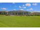 Enjoy outdoor living in the spacious screened-in patio surrounded by a well-manicured lawn and lush landscaping at 260 Rotonda E Blvd, Rotonda West, FL 33947
