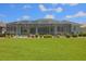 Relax in the spacious screened-in patio overlooking the lush backyard with manicured plants and ample seating at 260 Rotonda E Blvd, Rotonda West, FL 33947