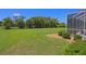 The spacious backyard offers a serene retreat with mature palms, lush greenery, and meticulously manicured landscaping at 260 Rotonda E Blvd, Rotonda West, FL 33947