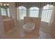 Bright bathroom featuring a clawfoot tub, glass block windows, and neutral color scheme at 260 Rotonda E Blvd, Rotonda West, FL 33947