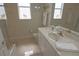 Bright bathroom featuring a shower, toilet, and large vanity with a sink at 260 Rotonda E Blvd, Rotonda West, FL 33947