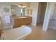 Elegant bathroom with a classic clawfoot tub, tiled flooring, vanity with storage, and stylish decor at 260 Rotonda E Blvd, Rotonda West, FL 33947