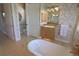 Bright bathroom featuring a clawfoot tub, vanity, and classic finishes at 260 Rotonda E Blvd, Rotonda West, FL 33947