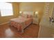 Cozy bedroom with vibrant bedding, beach house decor, and laminate wood flooring at 260 Rotonda E Blvd, Rotonda West, FL 33947
