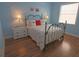 Comfortable bedroom featuring flamingo decor, a metal bed frame, and hard wood flooring at 260 Rotonda E Blvd, Rotonda West, FL 33947