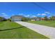 Well-maintained single-story home features a manicured lawn, long driveway, and a two-car garage at 260 Rotonda E Blvd, Rotonda West, FL 33947