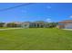 Well-maintained lawn and mature landscaping accentuate this desirable single-story home with a long driveway at 260 Rotonda E Blvd, Rotonda West, FL 33947