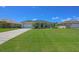 Well-maintained lawn and lush landscaping accentuate this desirable single-story home with a long driveway at 260 Rotonda E Blvd, Rotonda West, FL 33947