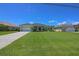 Well-manicured lawn and mature landscaping complement this single-story home with a spacious driveway at 260 Rotonda E Blvd, Rotonda West, FL 33947