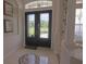 Elegant foyer featuring tile flooring with a compass design and a decorative glass double door at 260 Rotonda E Blvd, Rotonda West, FL 33947