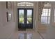 Elegant foyer featuring tile flooring with a compass design and a decorative glass double door at 260 Rotonda E Blvd, Rotonda West, FL 33947