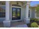 Elegant double front doors with glass inserts, flanked by columns, and a tile entryway enhance curb appeal at 260 Rotonda E Blvd, Rotonda West, FL 33947