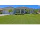 Beautifully landscaped single-story home with a well-manicured lawn and lush tropical foliage at 260 Rotonda E Blvd, Rotonda West, FL 33947
