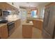 Charming kitchen with stainless steel appliances, light wood cabinets, and island at 260 Rotonda E Blvd, Rotonda West, FL 33947
