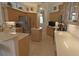 Kitchen featuring tile floors, wooden cabinets, stainless steel appliances, and a center island at 260 Rotonda E Blvd, Rotonda West, FL 33947