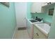 Laundry room featuring a washer, dryer, sink, and ample cabinet space for storage at 260 Rotonda E Blvd, Rotonda West, FL 33947