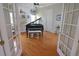 Bright room featuring beautiful hardwood floors, a grand piano and a comfortable chair at 260 Rotonda E Blvd, Rotonda West, FL 33947