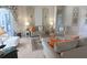 Bright living room featuring tile floors, a decorative rug, and neutral walls with modern furniture and decorations at 260 Rotonda E Blvd, Rotonda West, FL 33947