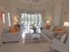 Bright living room with neutral decor, tile floors, and sliding glass doors overlooking the outdoor space at 260 Rotonda E Blvd, Rotonda West, FL 33947