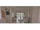 Bright living room features tile flooring, neutral walls, modern furniture, and a large window overlooking the pool at 260 Rotonda E Blvd, Rotonda West, FL 33947
