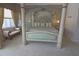 Spacious main bedroom featuring a decorative four-poster bed, a lounge bench, and neutral tones at 260 Rotonda E Blvd, Rotonda West, FL 33947