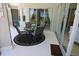 Outdoor dining area on a screened patio with table, chairs and sliding glass doors at 260 Rotonda E Blvd, Rotonda West, FL 33947