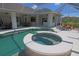 Expansive screened pool and spa area with multiple seating areas and outdoor kitchen at 260 Rotonda E Blvd, Rotonda West, FL 33947
