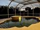 Inviting pool area with a spa and waterfall feature, all enclosed in a screened lanai for year-round enjoyment at 260 Rotonda E Blvd, Rotonda West, FL 33947