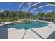 Gorgeous pool and spa with screened enclosure, surrounded by lush landscaping at 260 Rotonda E Blvd, Rotonda West, FL 33947