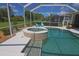 Inviting pool and spa with sun loungers and mature landscaping at 260 Rotonda E Blvd, Rotonda West, FL 33947