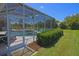 Enclosed screened-in pool area with an in-ground spa, ample seating, and serene backyard views at 260 Rotonda E Blvd, Rotonda West, FL 33947